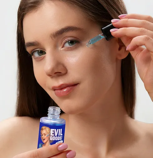 A woman applies a blue serum to her face with a dropper, holding a bottle labeled 'EVIL GOODS!'