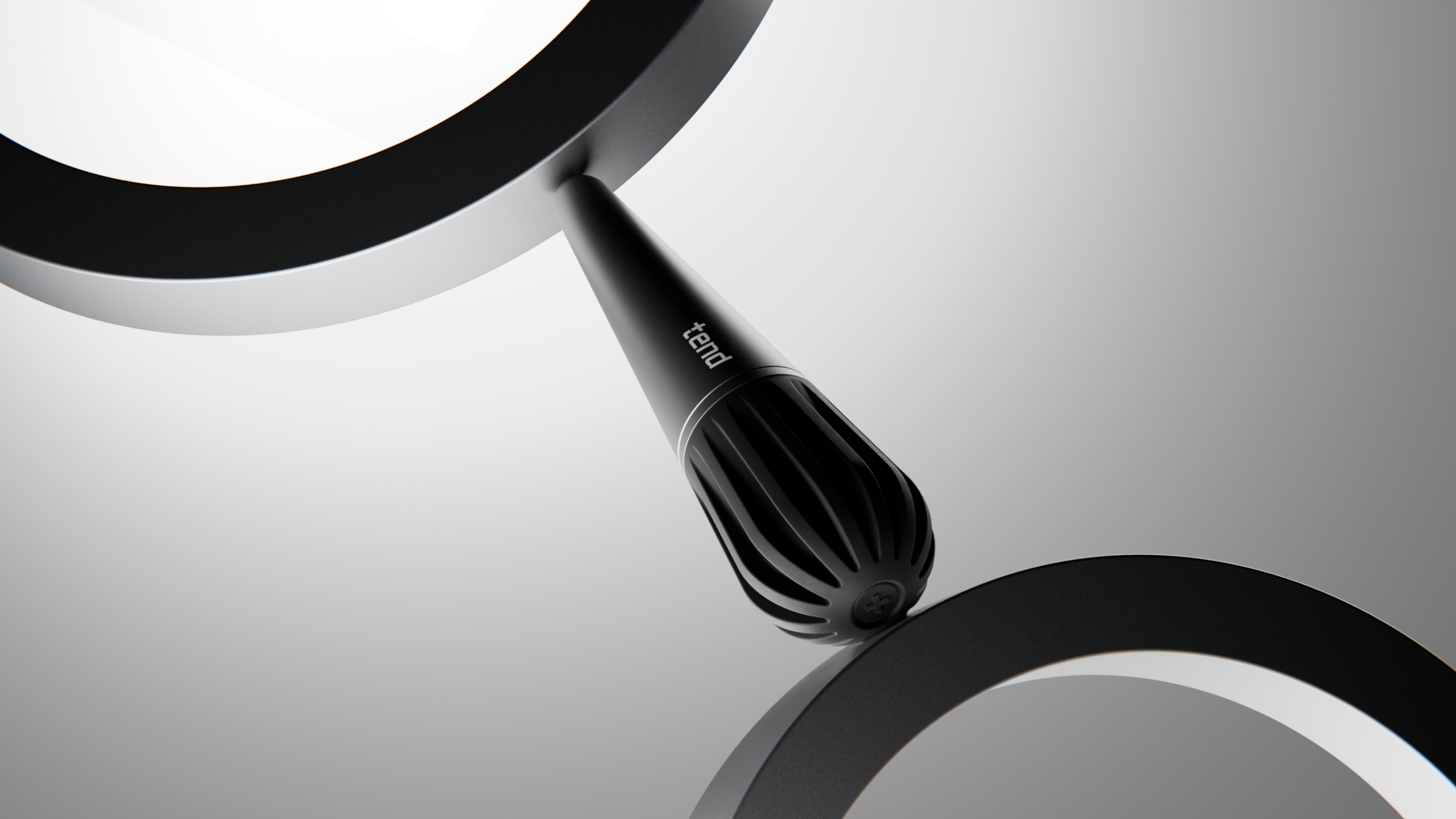 Black cylindrical device placed between two curved rings.