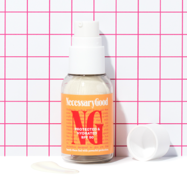 Bottle of skincare product with dispenser, cap, and cream sample on grid background.