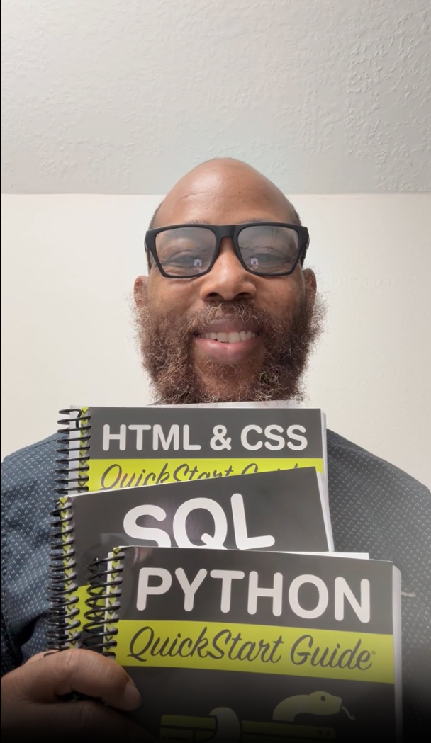 Person holding HTML, SQL, and Python QuickStart Guide books, smiling.