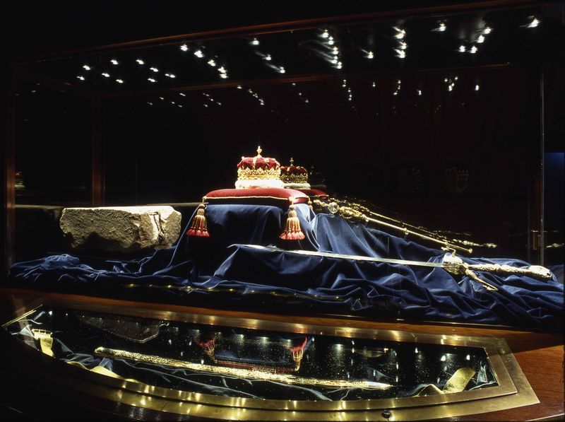 The Honours of Scotland and the Stone of Destiny in a glass display case with blue velvet.