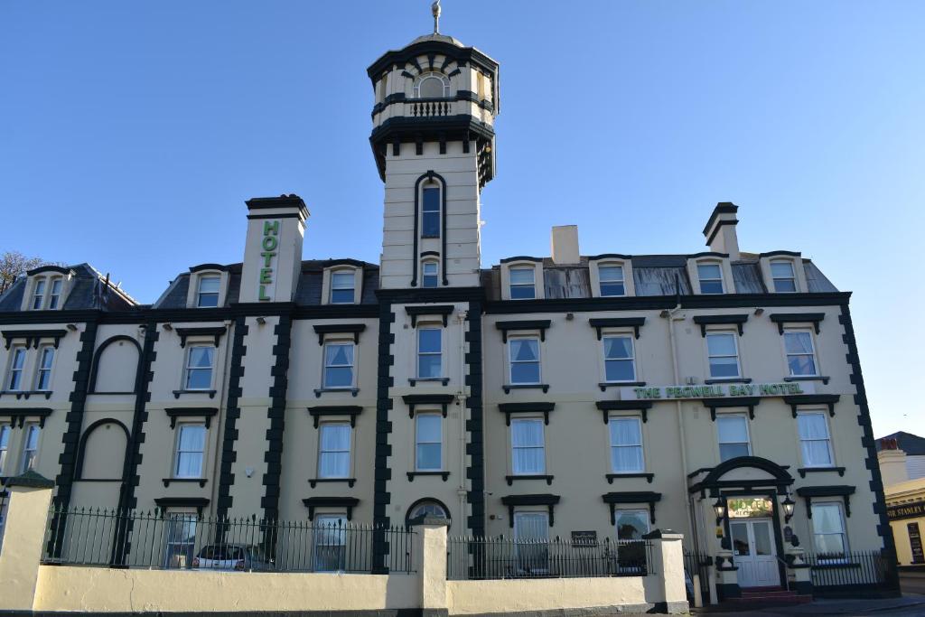 The exterior of The Pegwell Bay Hotel, a large cream and black building with a tower.