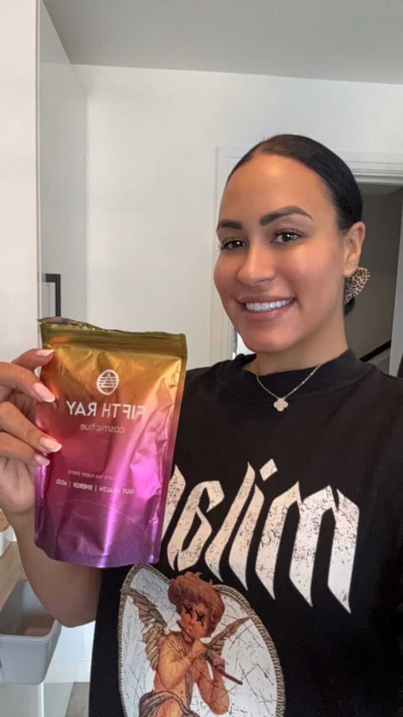 Person holding a colorful package labeled 'Fifth Ray' and smiling.