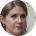 A low-resolution, circular, pixelated headshot of a woman with light brown hair.