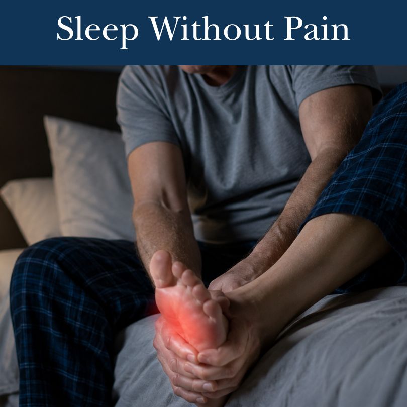 A man in pajamas sits on a bed, holding his foot which is glowing red to indicate pain.
