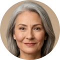 A circular headshot of a woman with long gray hair smiling gently.