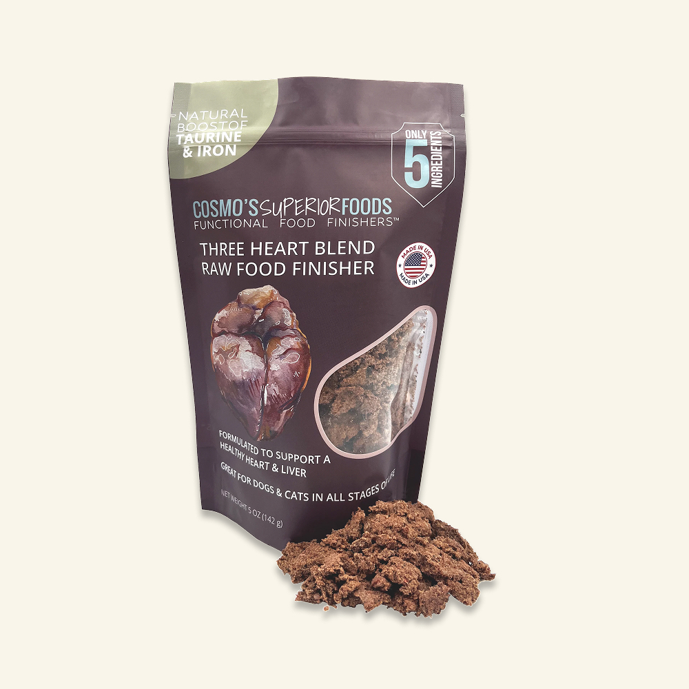 A bag of Cosmo's Superiorfoods Three Heart Blend Raw Food Finisher with a pile of the food in front.