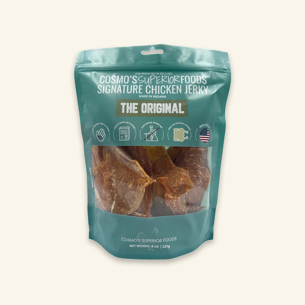A teal bag of Cosmo's Superior Foods Signature Chicken Jerky with a clear window showing the jerky inside.