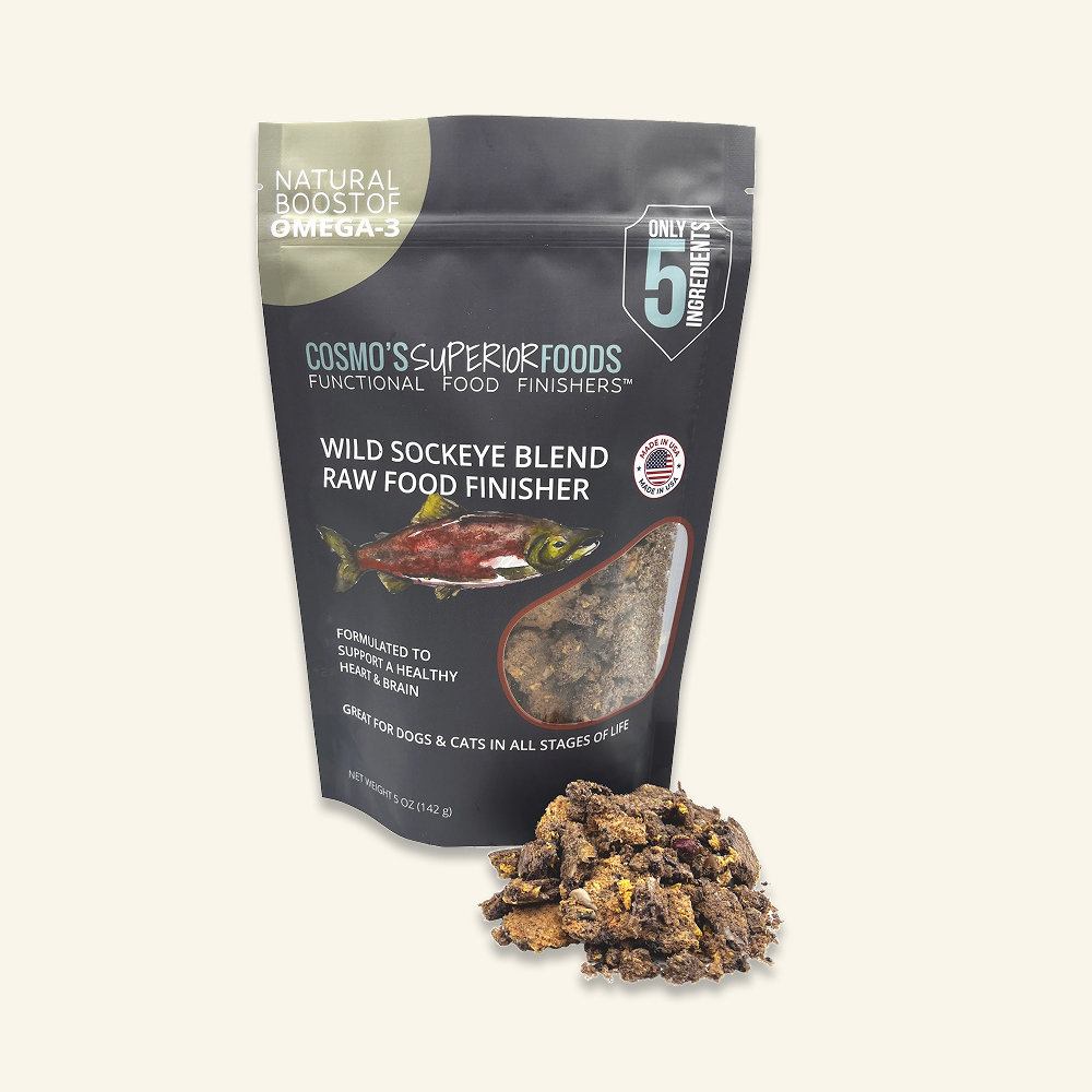 A bag of Cosmo's Superiorfoods Wild Sockeye Blend Raw Food Finisher with a pile of the food.