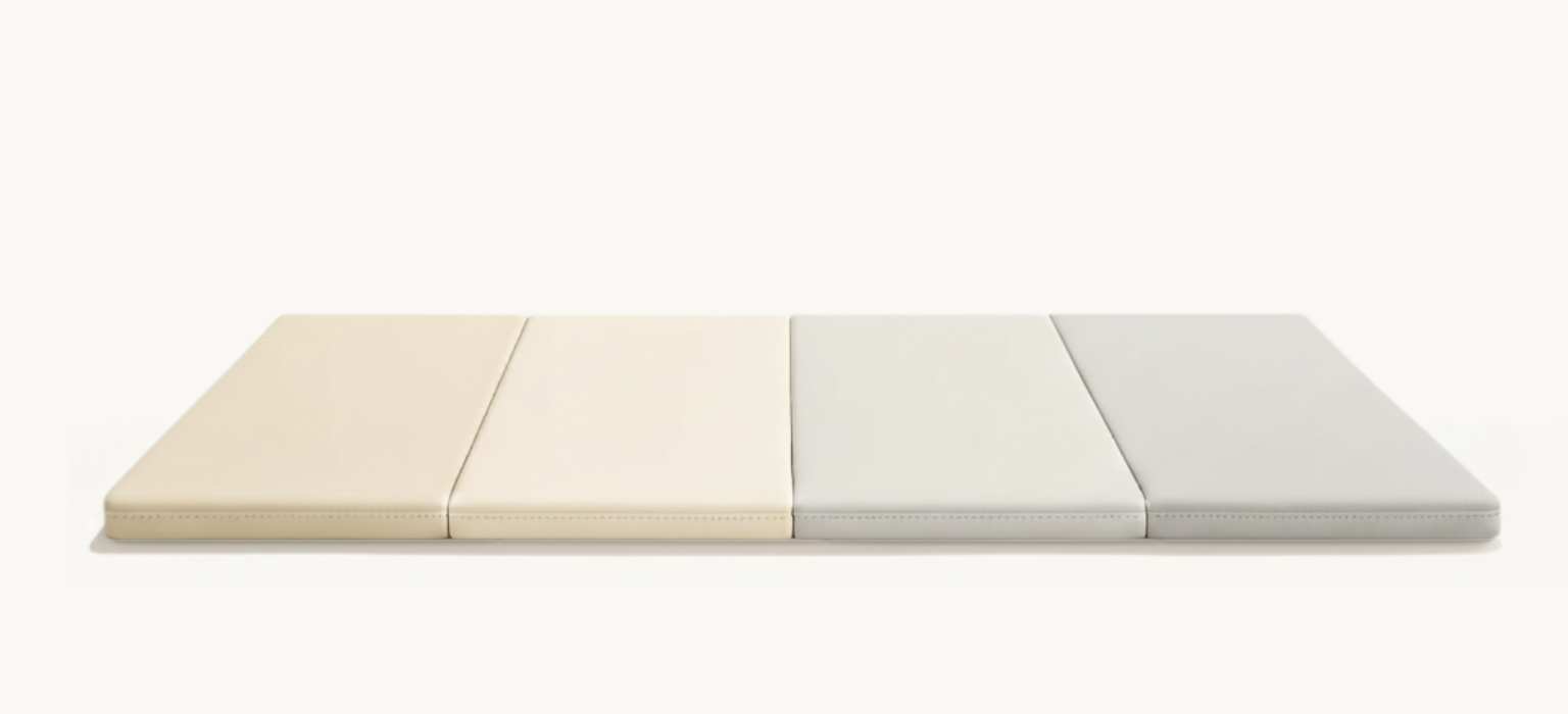 Four rectangular, padded panels arranged side-by-side, ranging in color from cream to light grey.