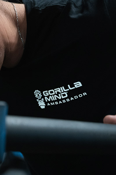 Close-up of 'Gorilla Mind Ambassador' logo on a black shirt.