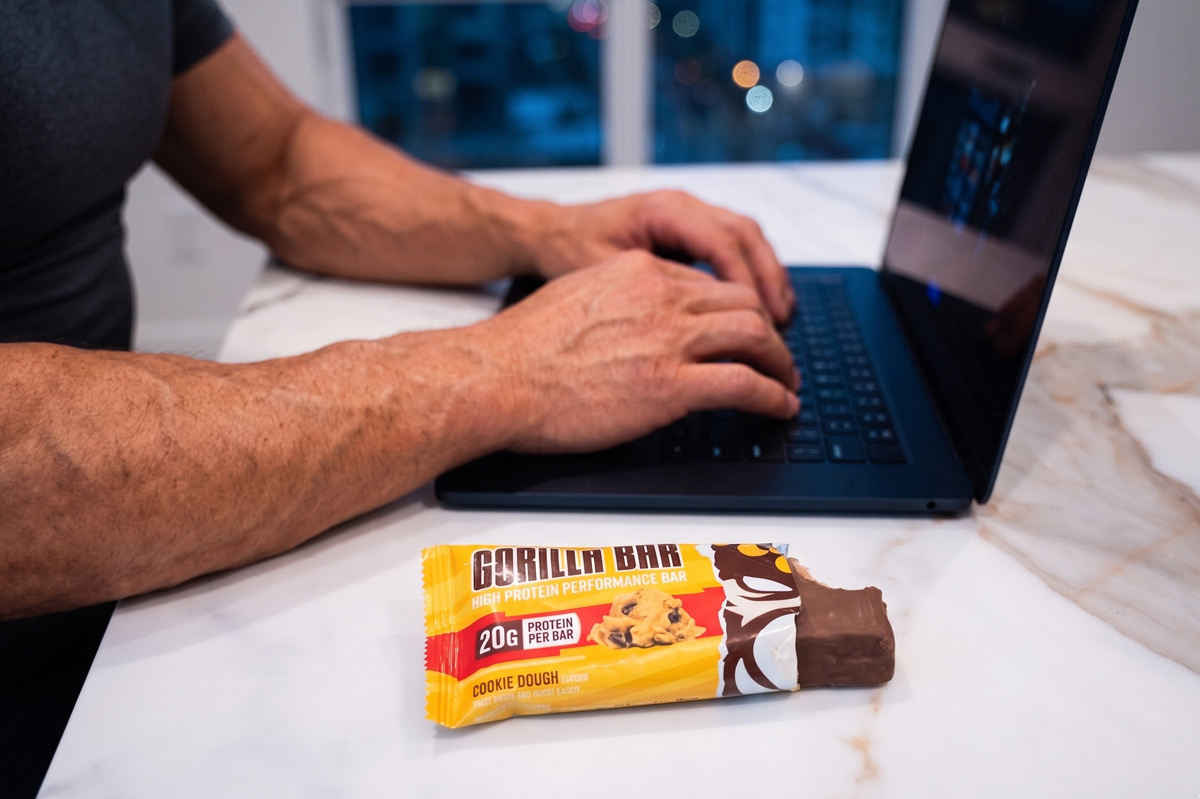 Gorilla Bar protein bars displayed with peanut butter cups and scoops of chocolate chip cookie dough.