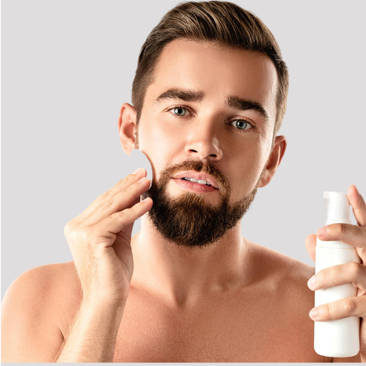 Man applying skincare product with a cotton pad.