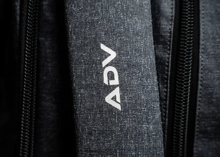 Close-up of a fabric with the letters 'ADV' and zippers.