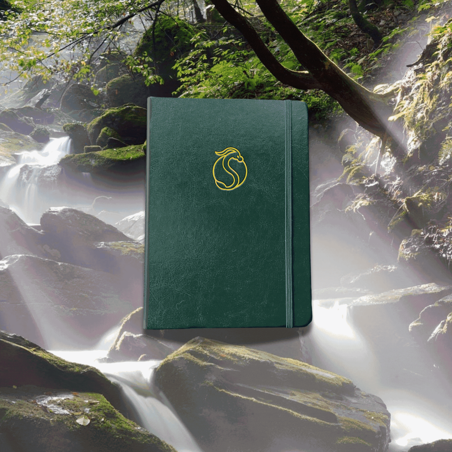 Green notebook with emblem on nature background of a waterfall and mossy rocks.