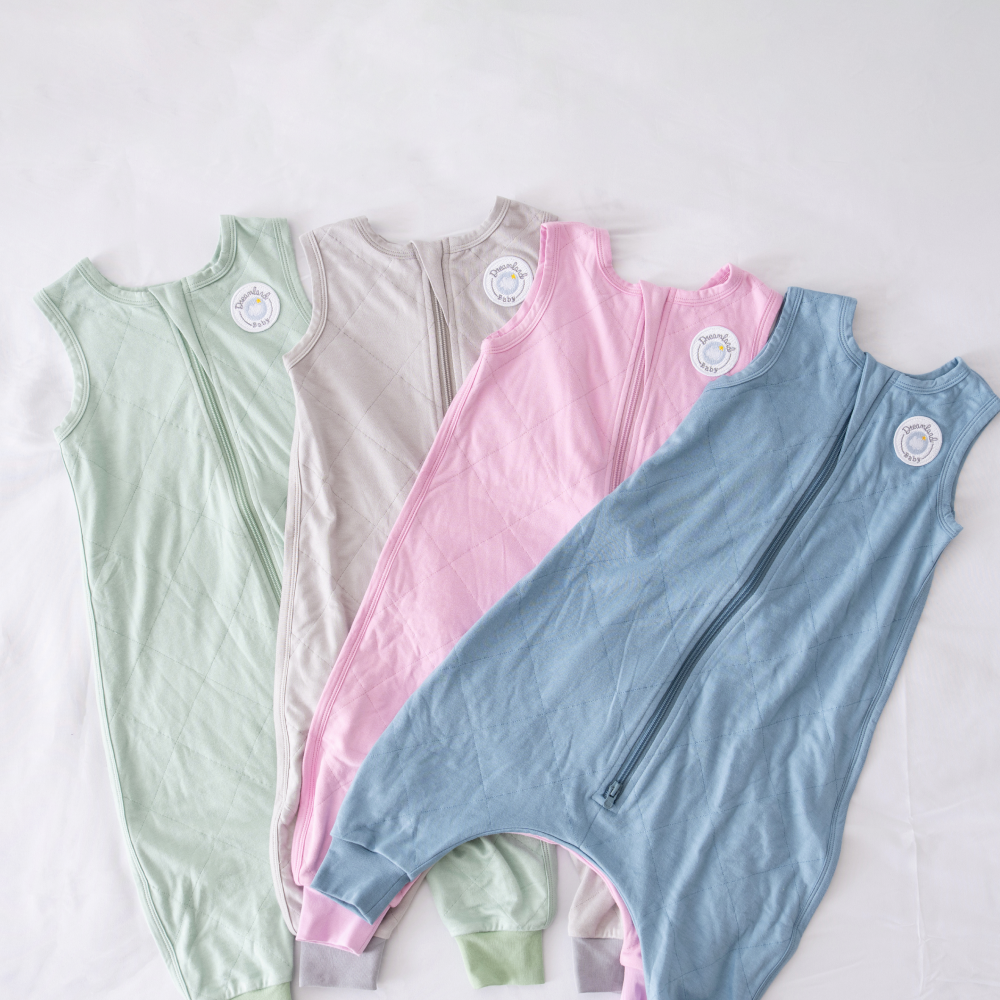Four sleeveless baby sleeping bags in pastel colors on a white background.