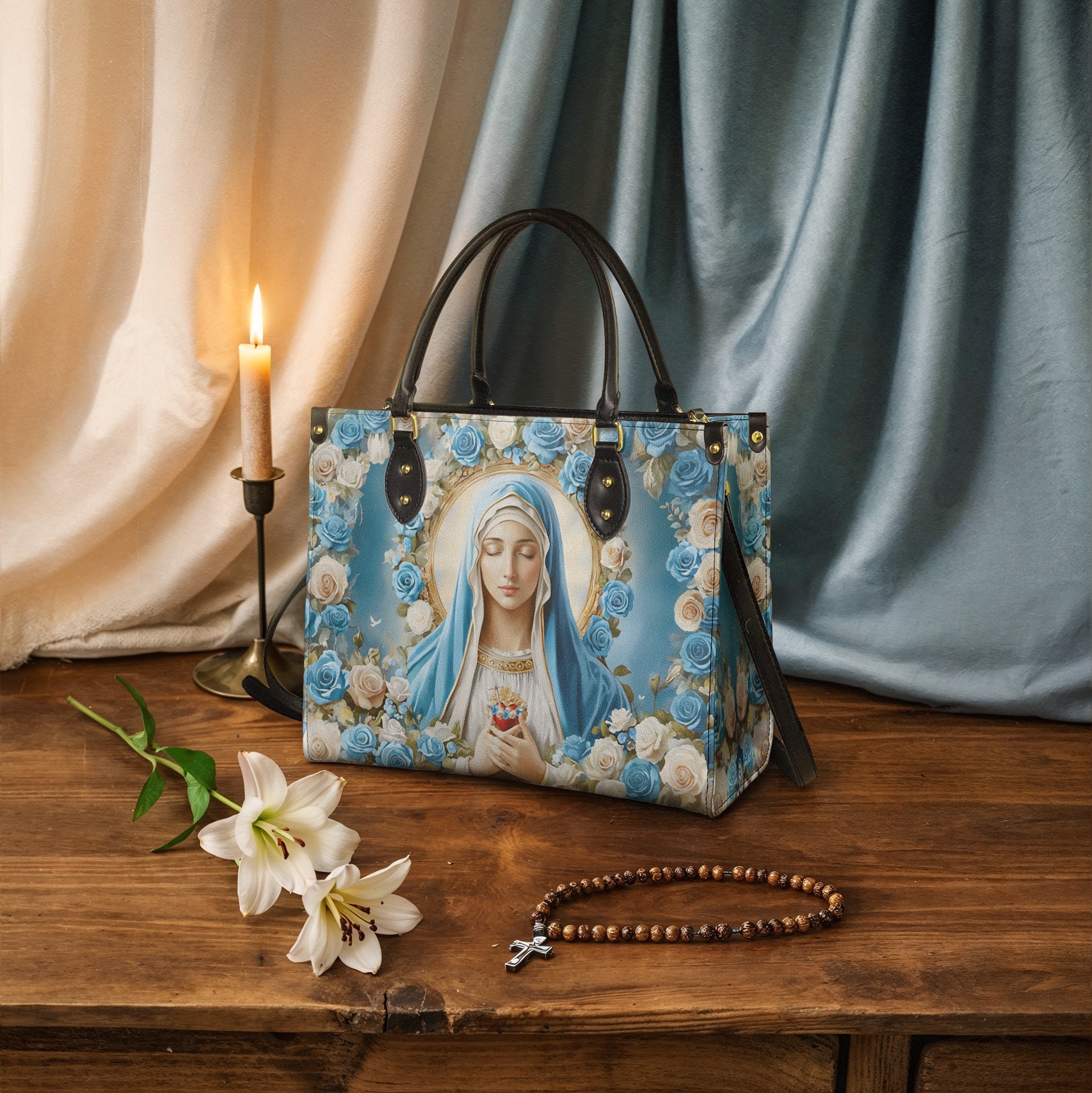 Handbag with religious image, candle, lilies, and rosary on wooden table.