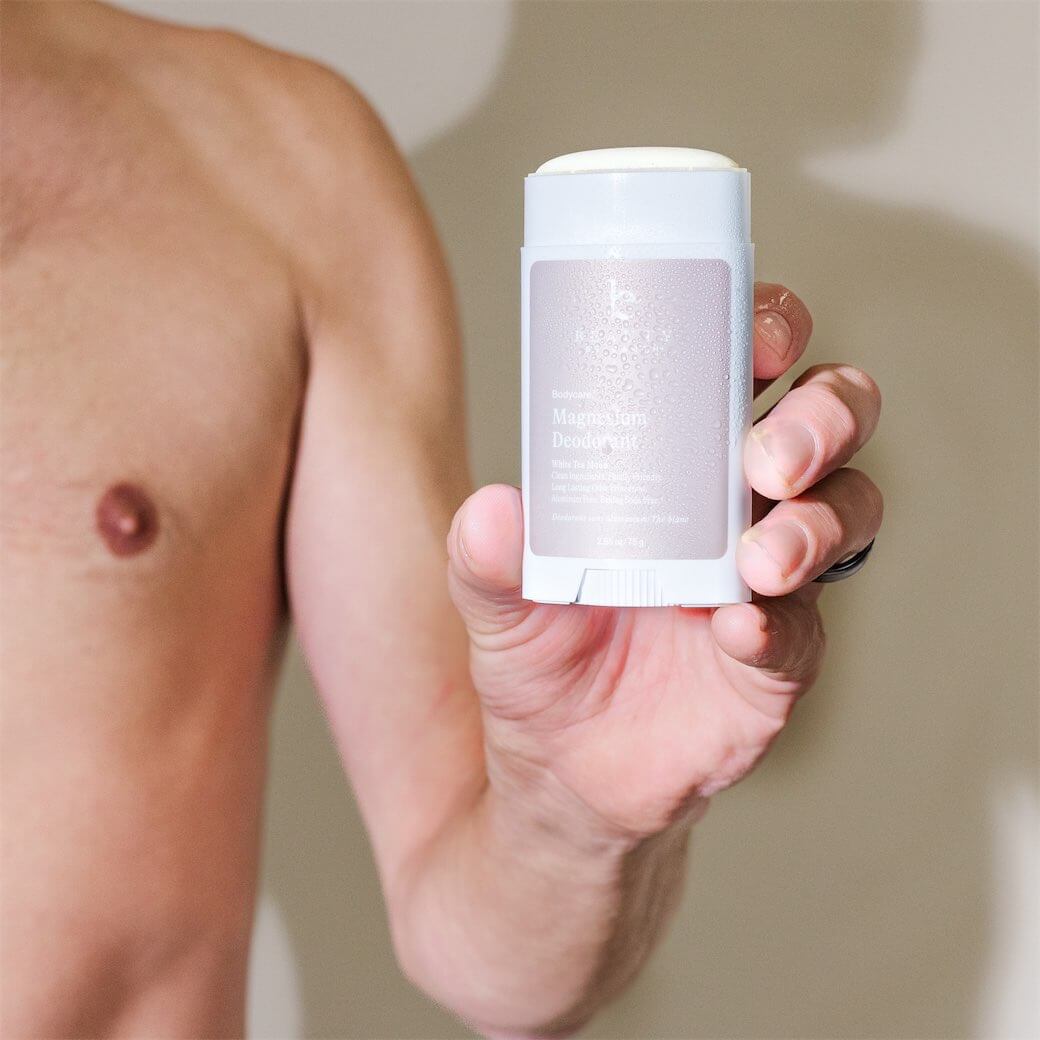 Person holding a stick of magnesium deodorant.