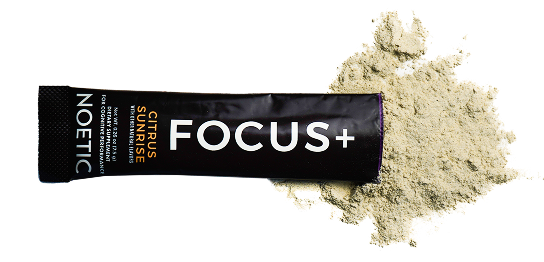 Black packet labeled 'FOCUS+ Citrus Sunrise' with beige powder spilling out.