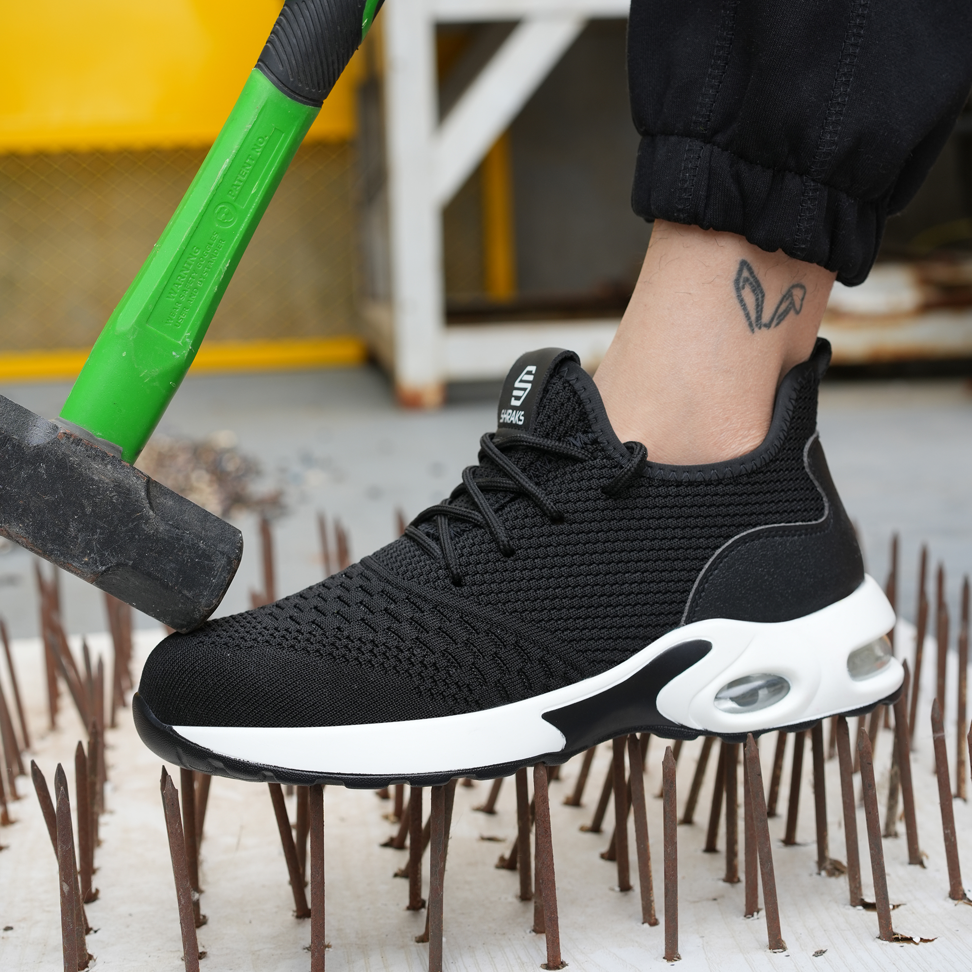 A safety shoe is being tested for durability by stepping on nails and being hit with a hammer.