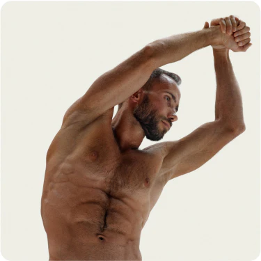 Man stretching with arms raised overhead.