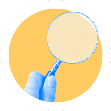 A hand holding a magnifying glass on a yellow circular background.