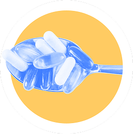A blue spoon holding assorted translucent capsules and tablets on a yellow background.
