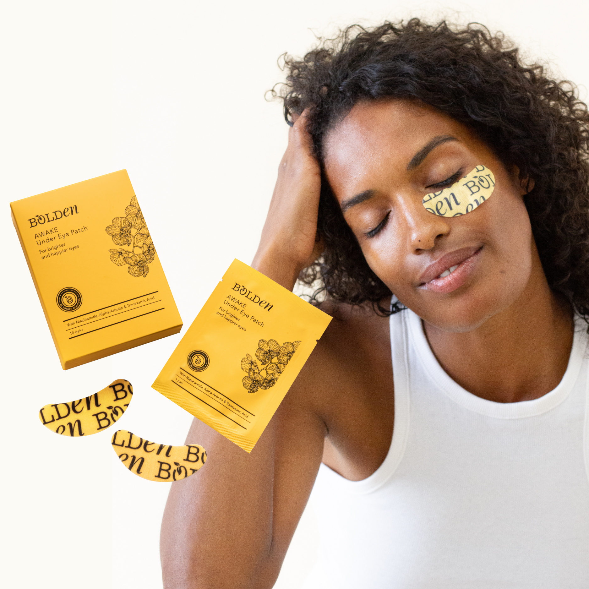 Person smiling with under-eye patches and product packaging.