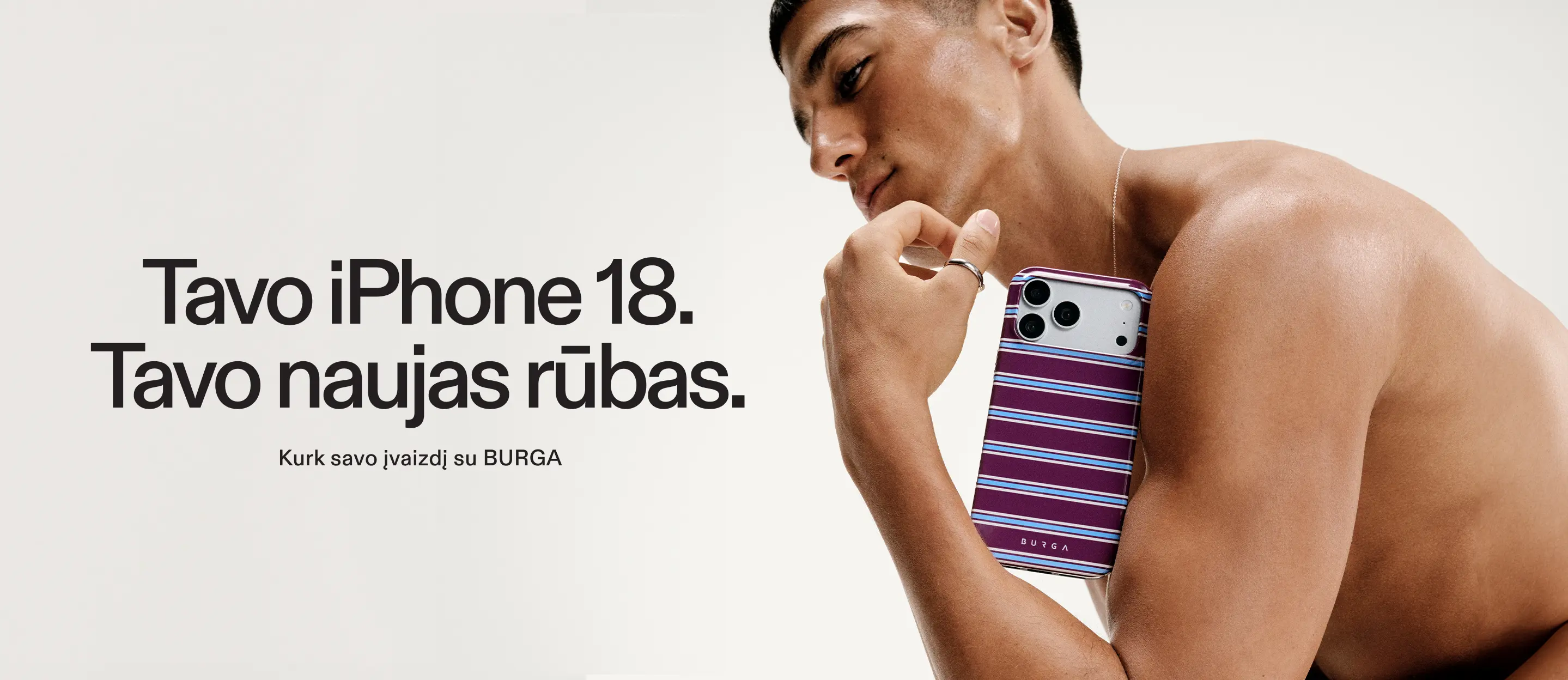 A shirtless man holds an iPhone in a purple and blue striped case against a white background.