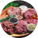 A variety of raw meat cuts with vegetables and spices.