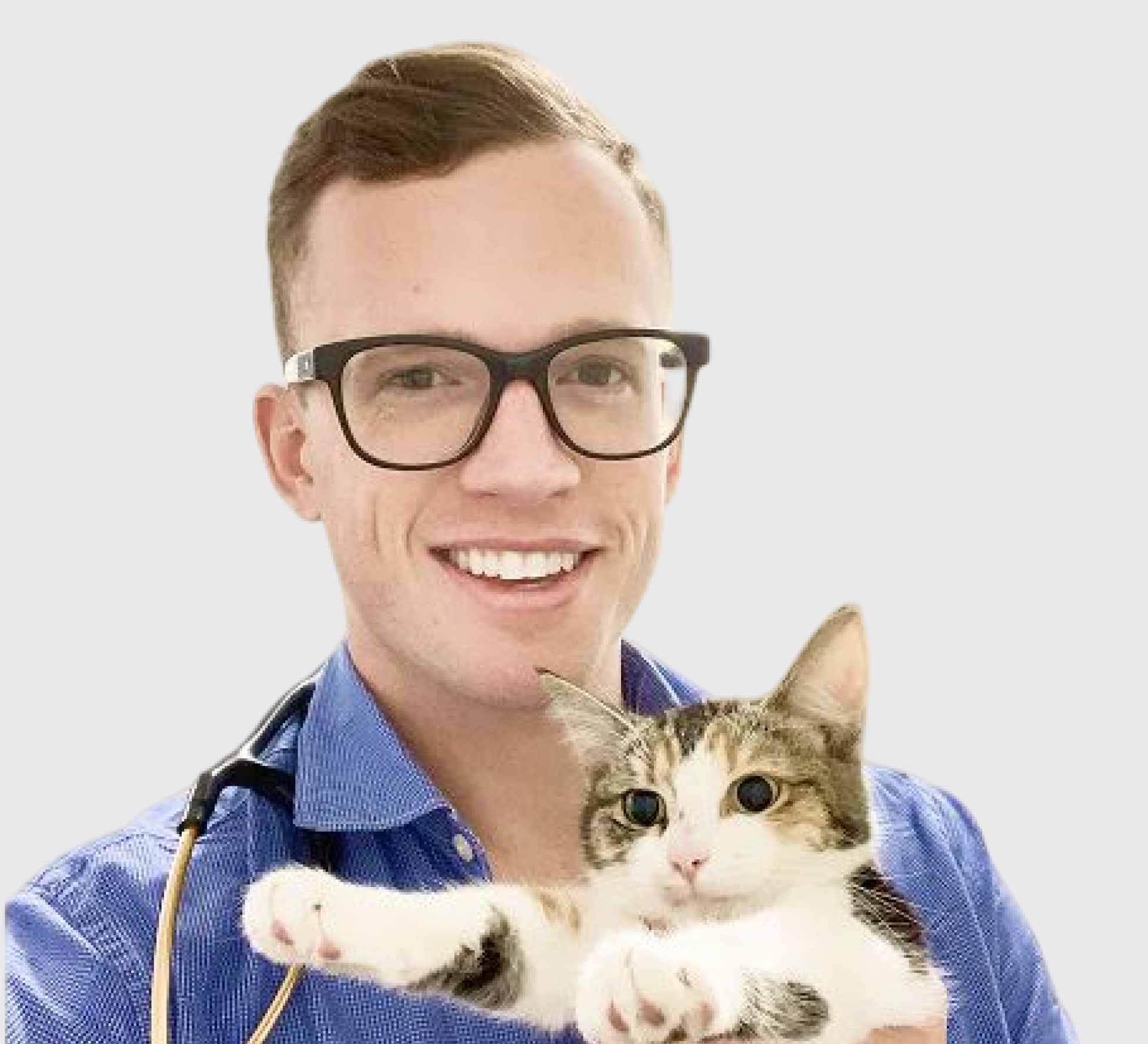 Person wearing glasses holding a cat, smiling.