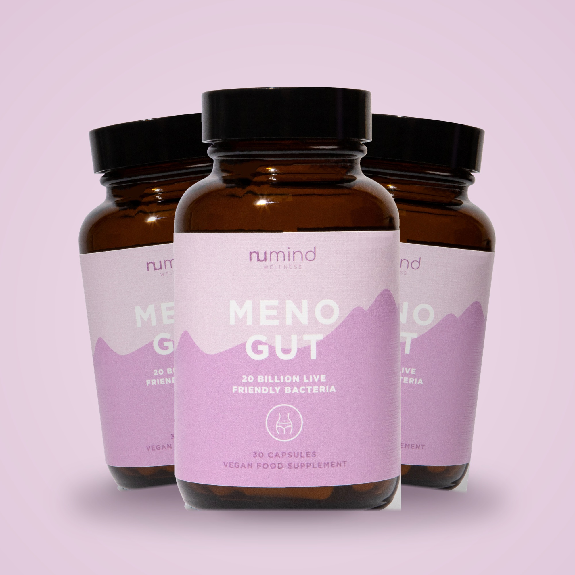 Three brown bottles of Numind Wellness Meno Gut supplements against a pale purple background.