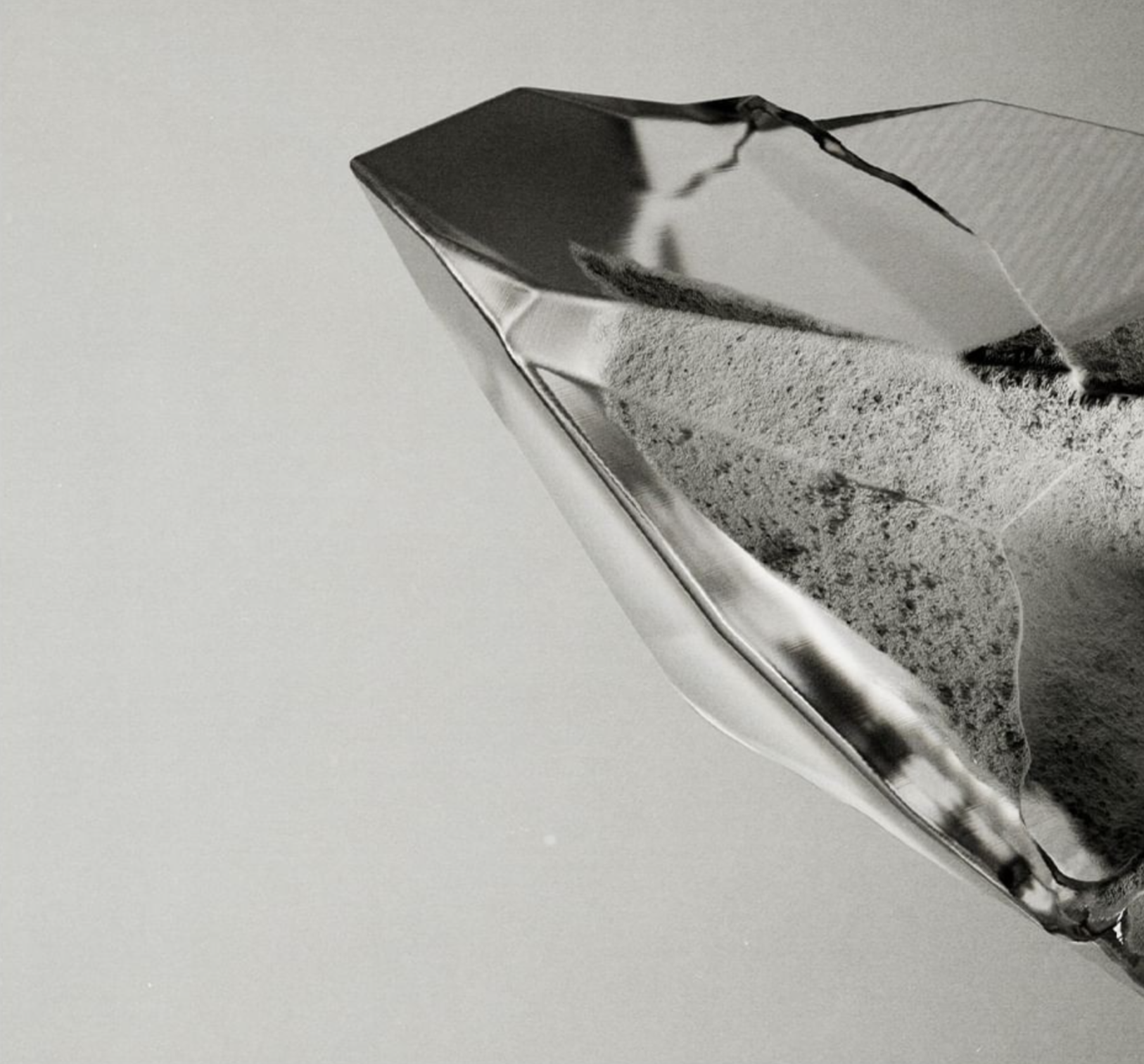 Close-up of a faceted, transparent object with a textured interior.