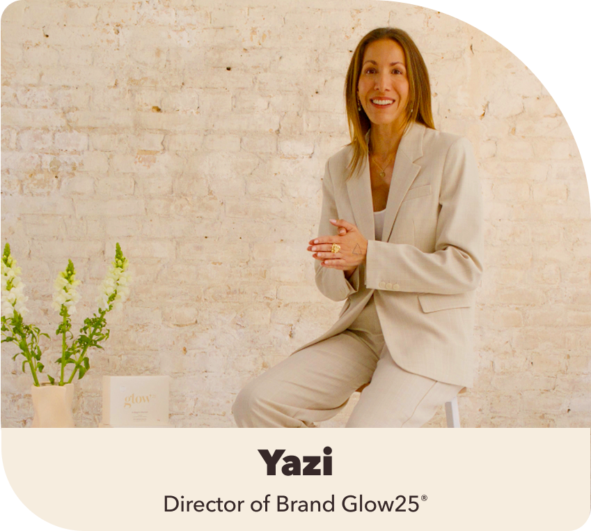 Person in a beige suit sitting in front of a brick wall with flowers and a product box.
