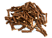 A pile of dried, chopped brown roots on a circular white background.
