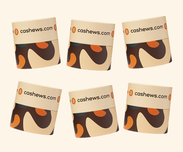 Six cylindrical containers with 'cashews.com' branding and an abstract pattern, arranged in two rows.