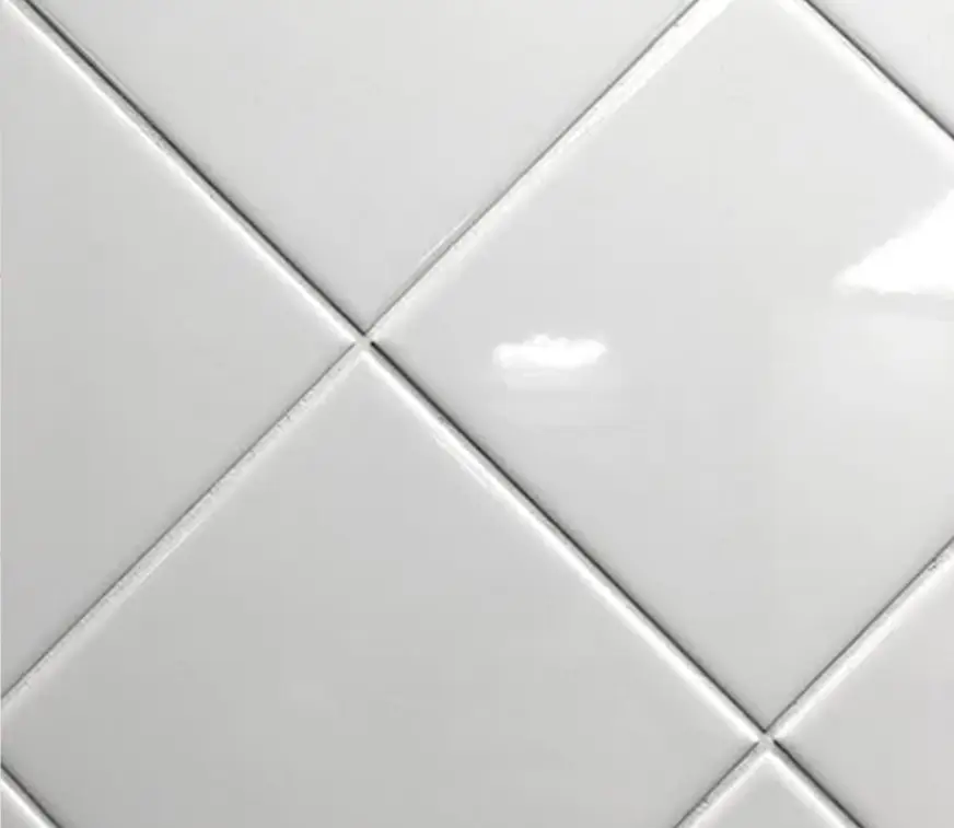 White ceramic tiles arranged in a diagonal pattern.