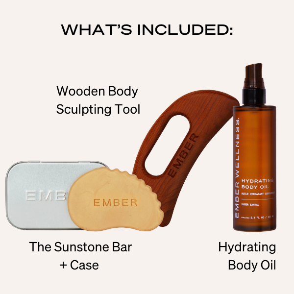 An Ember Wellness set including a wooden body sculpting tool, a sunstone bar with case, and hydrating body oil.