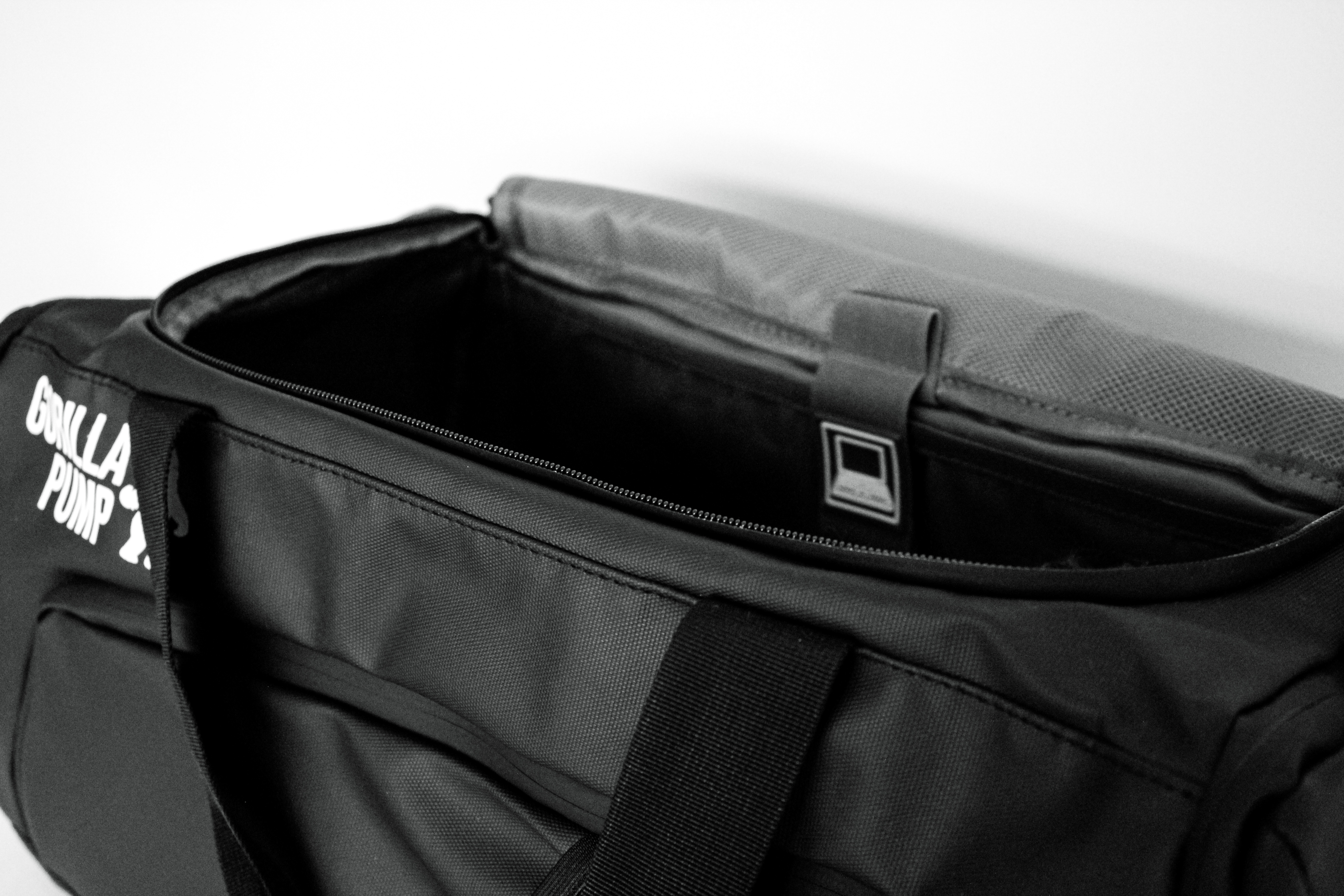 Black duffel bag with 'Gorilla Pump' logo, partially open.