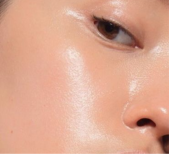 Close-up of a person's eye and smooth, glowing skin.