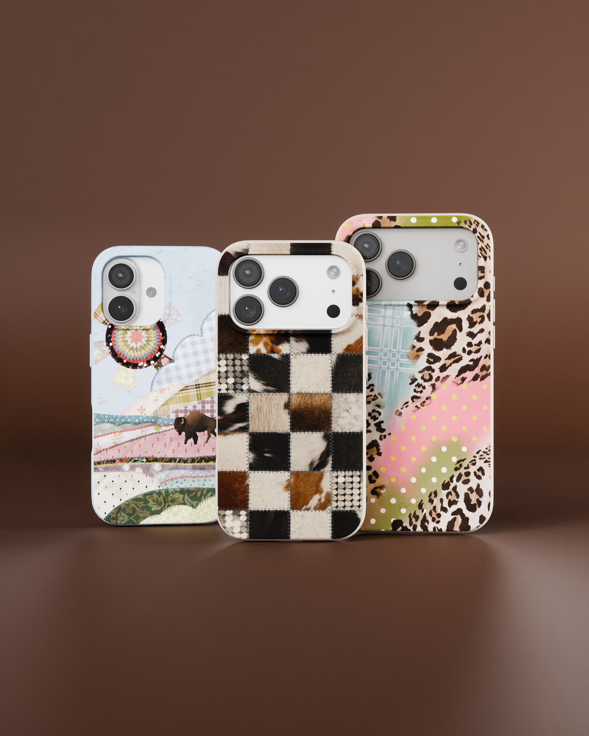 Three iPhones in cases with eclectic patchwork designs, including cowhide, a buffalo landscape, and leopard print.