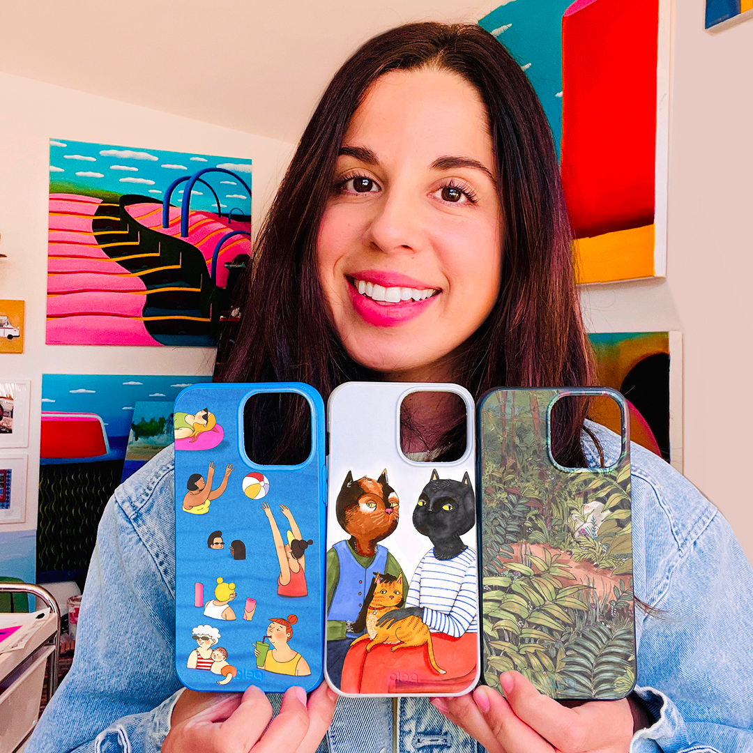 Woman holding a phone with a colorful case in front of her face against a pink background.