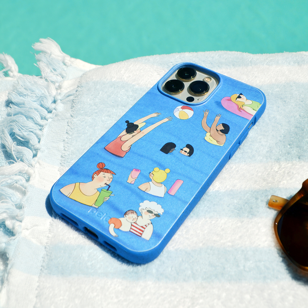 A blue phone case with illustrations of people at the pool, resting on a striped towel.