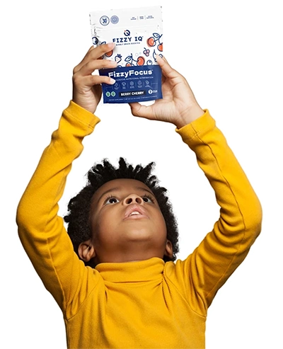 Child in yellow shirt holding a Fizzy Focus package overhead.