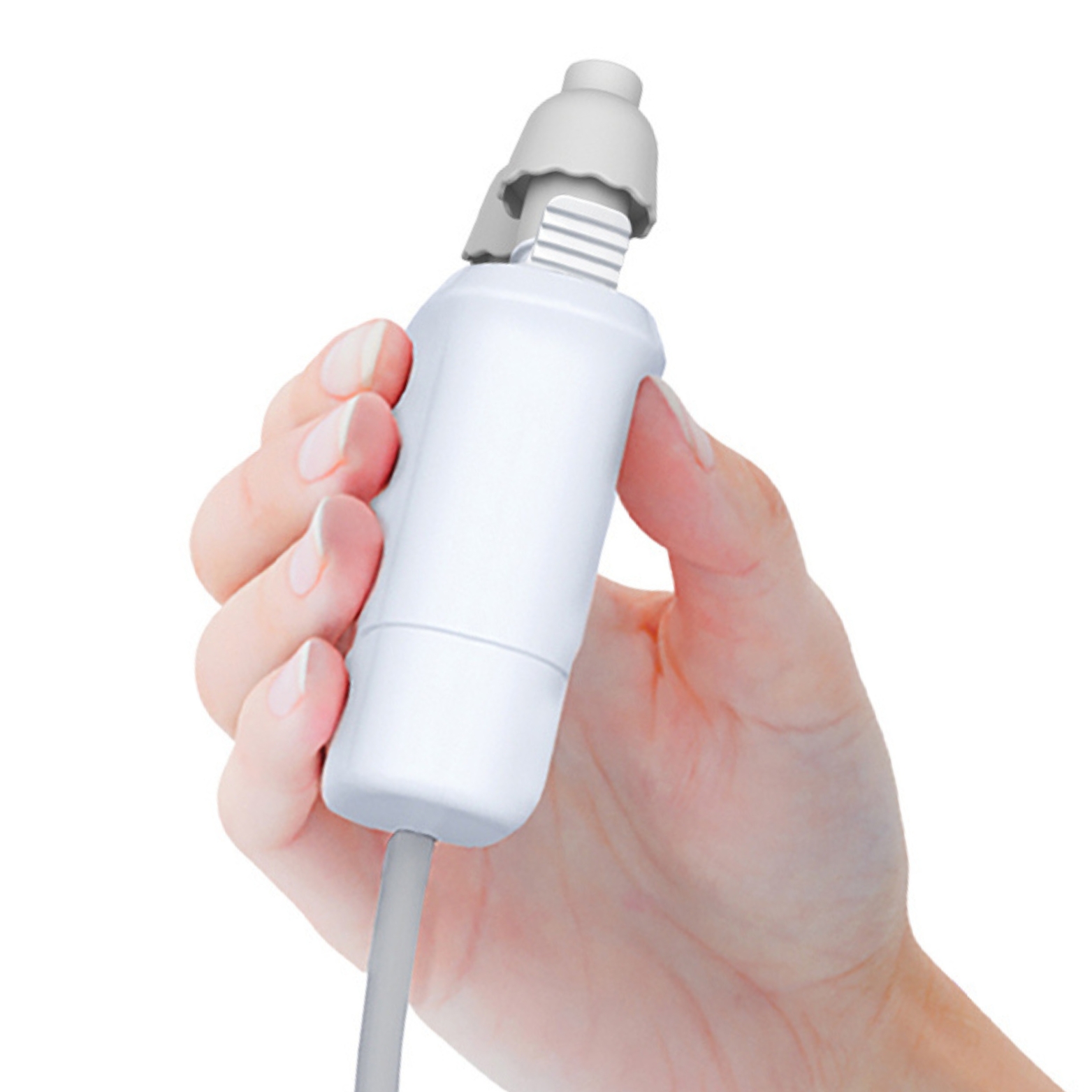 Hand holding small white electric device with rubber tip and cable.