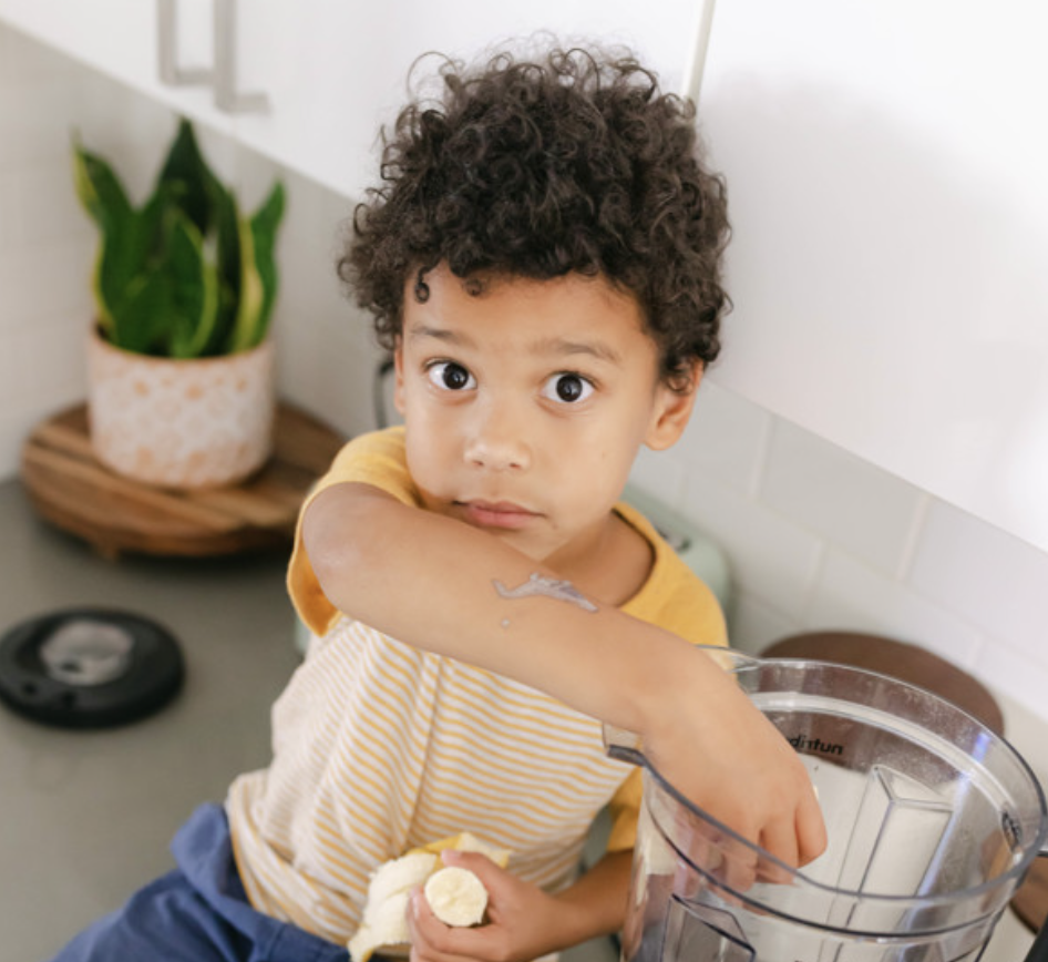 A woman helps a child drink from a bottle; chicory root with blue flowers.