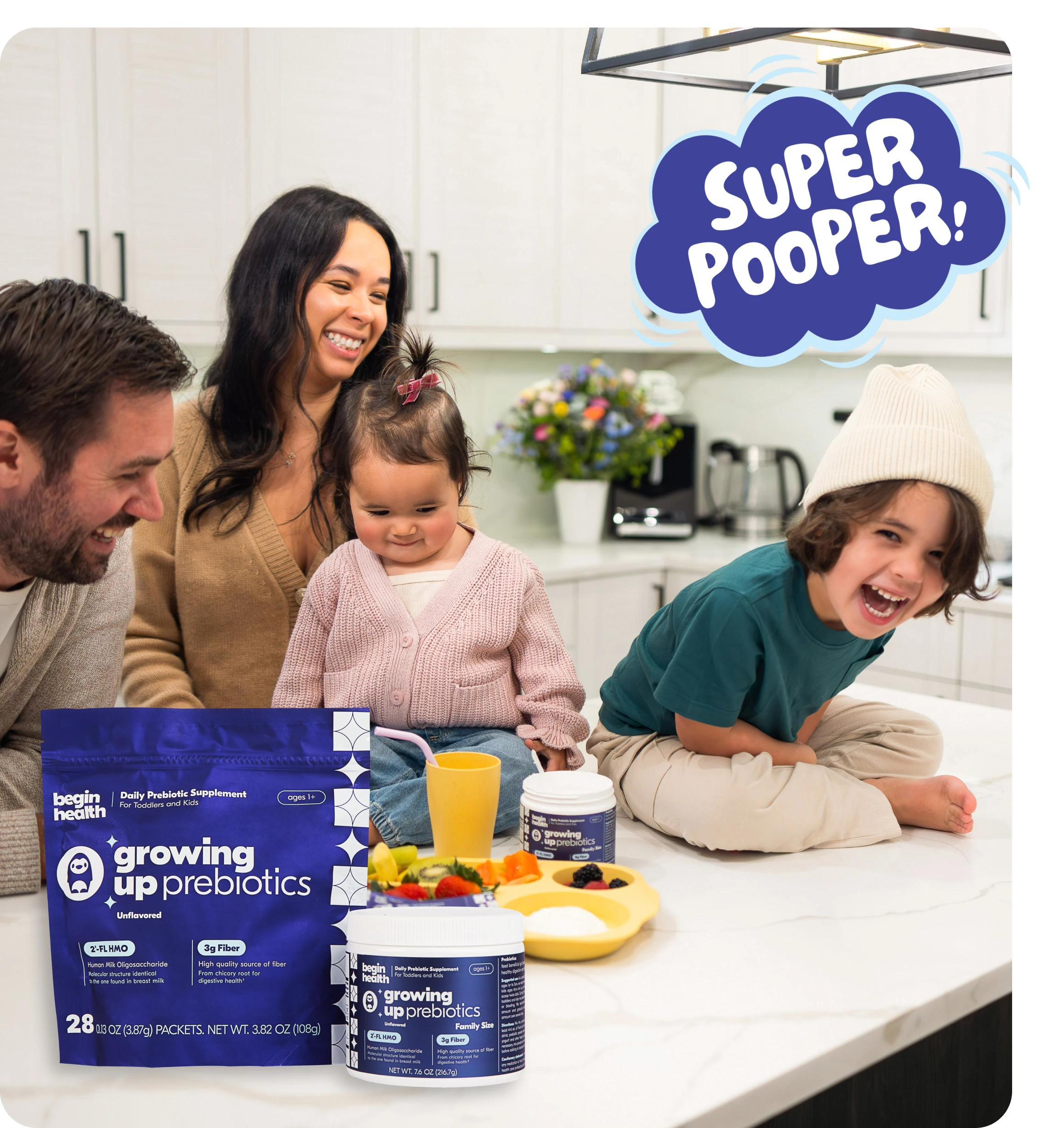 Family smiling in kitchen with children sitting on counter.