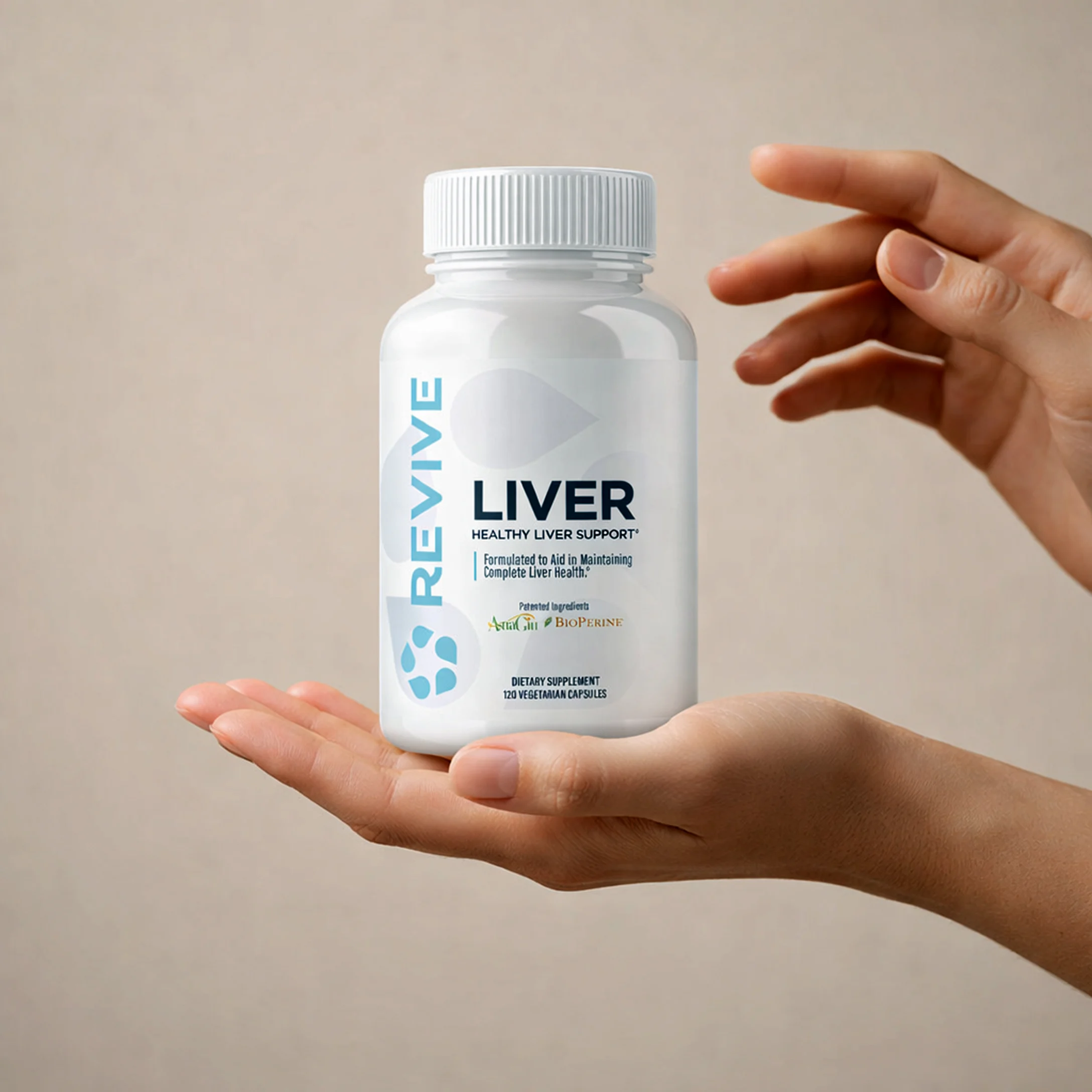 A pair of hands holding a white bottle of Revive Liver Support supplements against a neutral background.