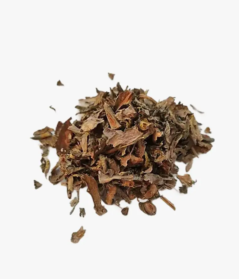 A small pile of dried, brown loose-leaf tea against a white background.