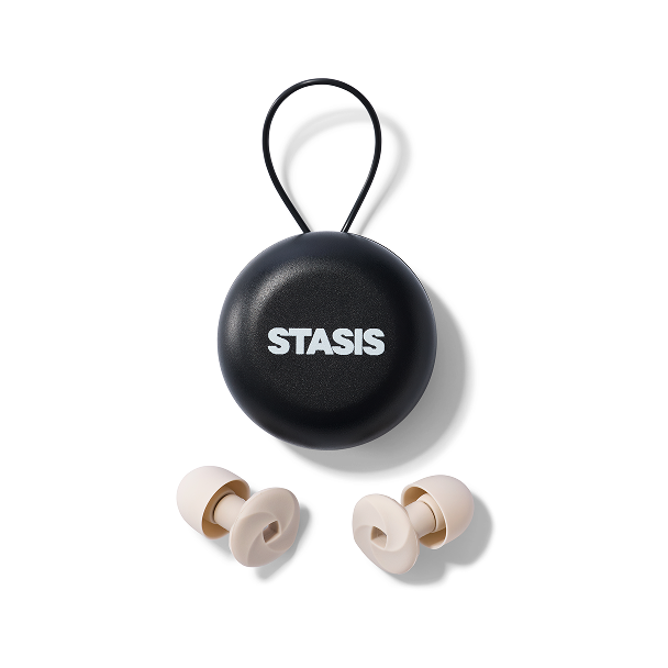 Black round case labeled 'STASIS' with silicone earplugs below.